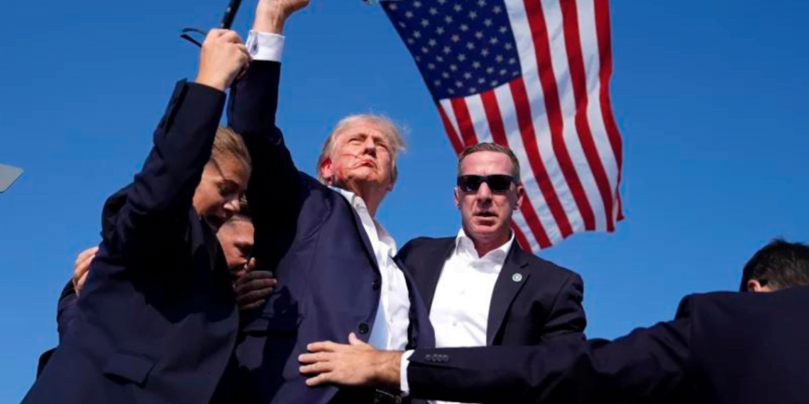 Former President Donald Trump is rushed offstage during a rally in Butler, Pa. Evan Vucci/AP